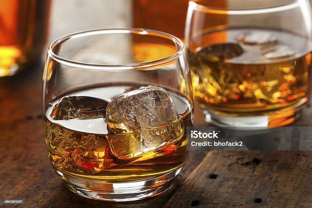 Alcoholic Whiskey Bourbon in a Glass with Ice Alcoholic Amber Whiskey Bourbon in a Glass with Ice Scotch Whiskey Stock Photo
