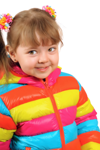 Smiling three year old girl in a bright spring clothes