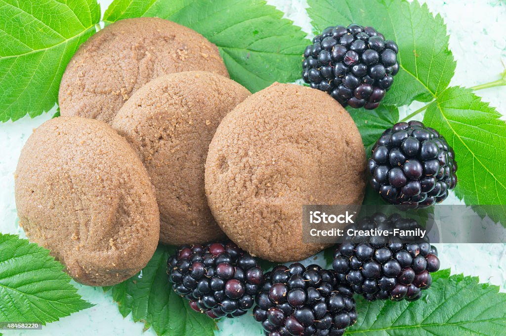 Integral biscuits and fresh blackberries on blackberry leaves Integral biscuits and fresh blackberries on blackberry leaves. Healthy dessert 2015 Stock Photo