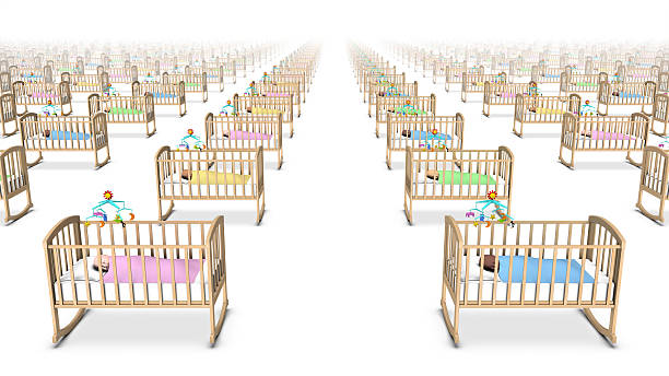 Side high angle view of babies in cribs stock photo