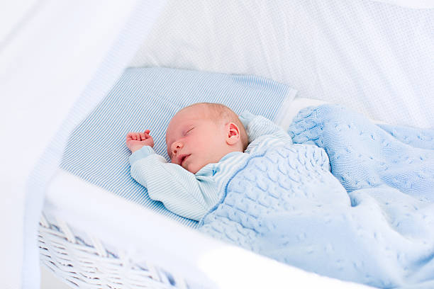 istock Newborn baby boy in white bassinet 484582528
