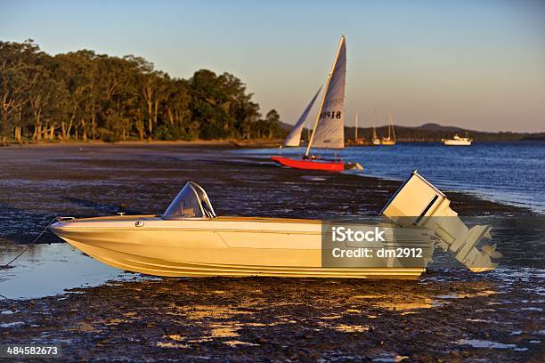 Speedboat On Shore At Low Tide Stock Photo - Download Image Now - Day, Estuary, Gold Colored