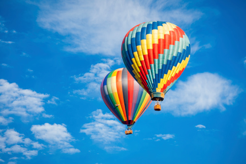 Beautiful Hot Air Balloons Against a Deep Blue Sky and Clouds.