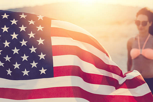 istock American flag waving at the beach 484583182