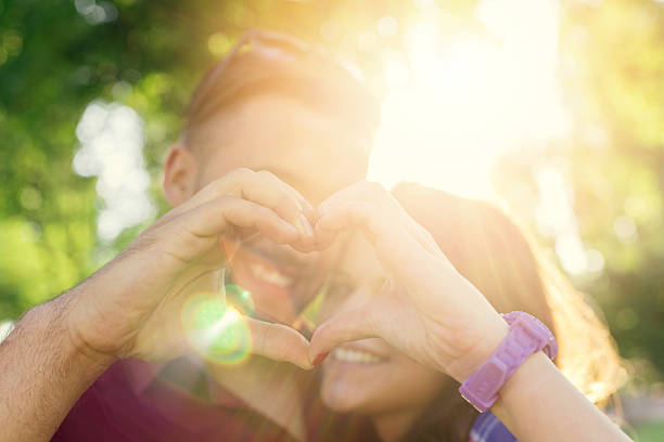 istock Young couple showing heart shape symbol 484583188