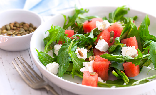 Watermelon salad with feta cheese, toasted pumpkin seeds, arugula, spinach and mint.