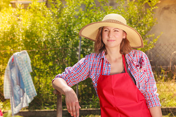 istock woman standing with shovel in garden 484587648