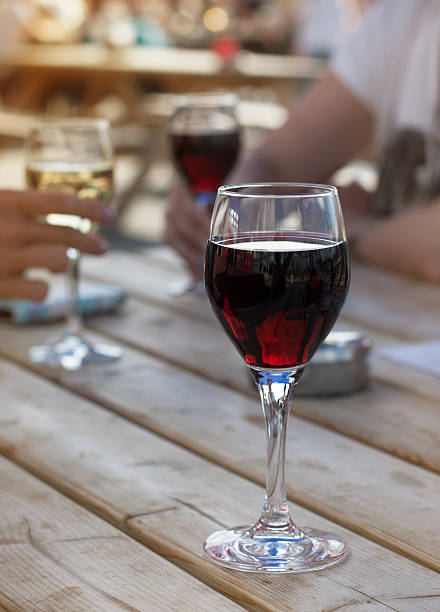 istock Glass of red wine on the table 484588068