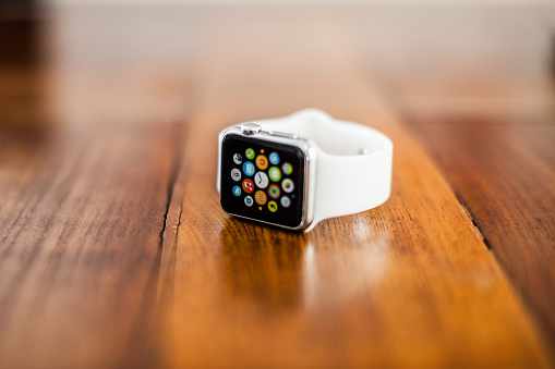 Rome, Italy - August 17, 2015: A 38mm stainless steel Apple Watch with white sports band. This smartwatch has a 38 mm screen in a silver aluminium case with a white, soft plastic sports band. Released on Friday April 24, 2015 the display shows apps available on the watch.