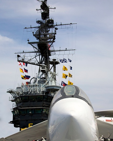 Tower of the USS Midway and an aircraft sitting on the deck