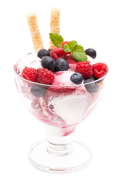 istock ice cream sundae with various wild berries isolated on white 484593174