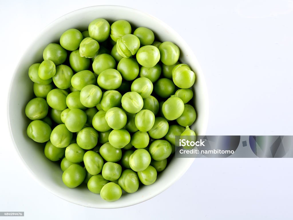 Green peas in the bowl isolated on white Green peas in the bowl isolated on white background Green Pea Stock Photo