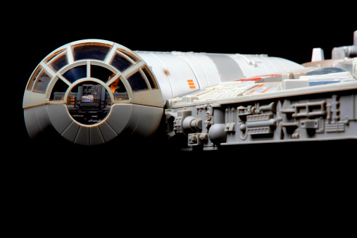 Vancouver, Сanada - February 17, 2014: A toy Millenium Falcon, from the Star Wars movie franchise, on a black background. The toy is made by Hasbro