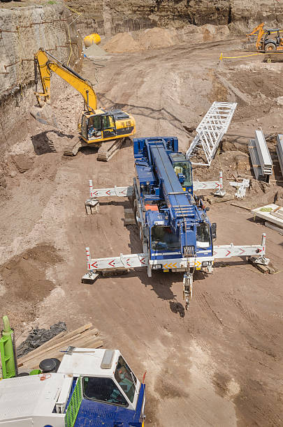 istock Excavator along a crane truck 484604881