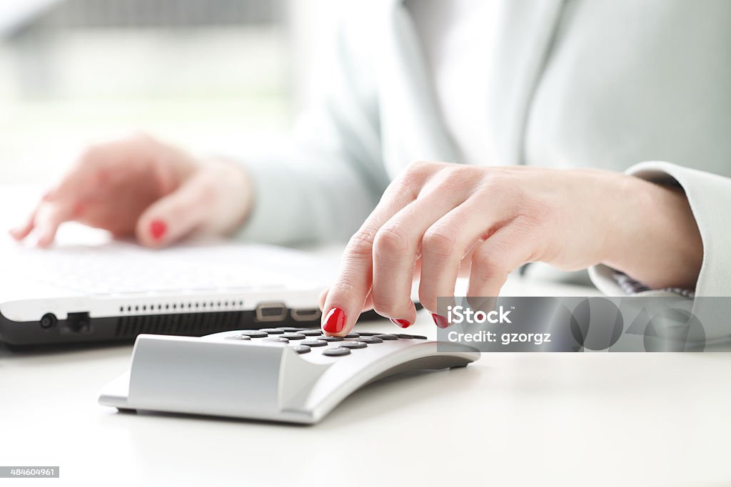 Businesswoman analyzing data Close-up of businesswoman's hands working on accountancy with laptop and calculator. Small business. Administrator Stock Photo