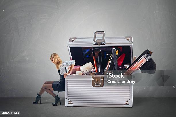 Young Attractive Woman Pushing Big Hevy Case With Cosmetics Stock Photo - Download Image Now