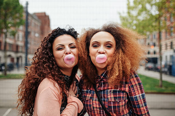 istock Best friends chewing bubble gum 484608290
