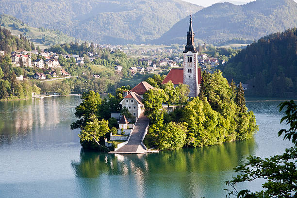 islad on lake Bled Island on Lake Bled and the alps. gorenjska stock pictures, royalty-free photos & images