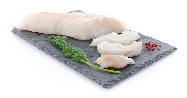 fillet cod mentah segar di piring batu tulis - ikan kod foto potret stok, foto, & gambar bebas royalti