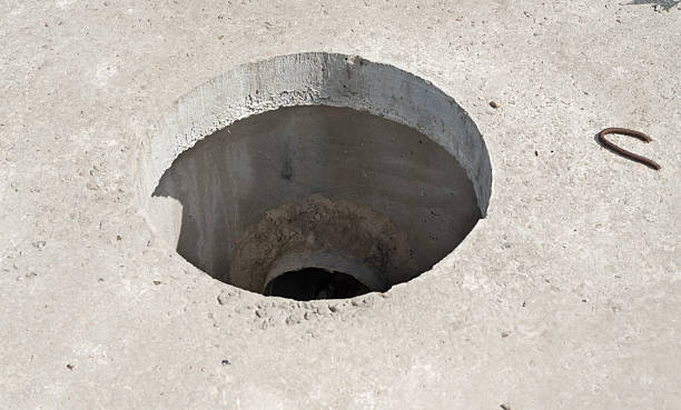 istock Manhole without cover in new concrete block 484614642