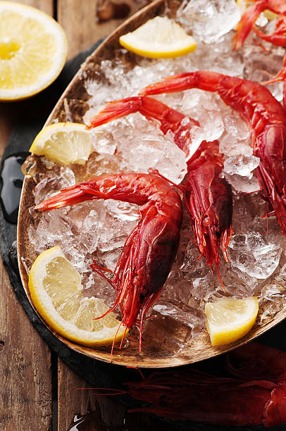 istock Raw fresh shrimps with ice and lemon 484615802
