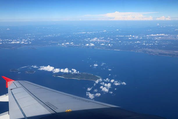 istock View of plane wing with clouds and landscape 484615930
