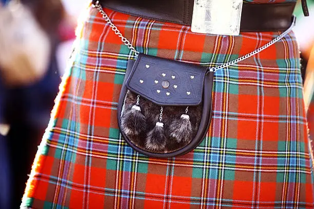 Color detail of a traditional Scottish kilt, with a bag.