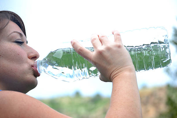 istock Woman athlete drinking water 484620547