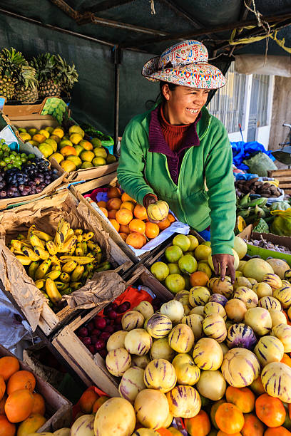 istock Peruvian woman selling fruits, Chivay 484620875