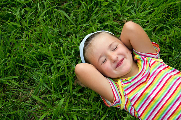 istock Girl lying in grass 484621059