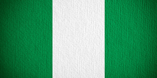 Flag of the Federal Republic of Nigeria on modern metal flagpole.