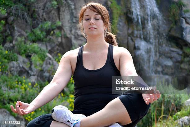 Woman Practicing Yoga With Waterfall Background Stock Photo - Download Image Now - Adult, Balance, Beach