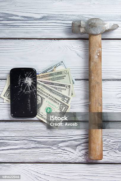 Modern Broken Mobile Phone And Money On White Wooden Background Stock Photo - Download Image Now
