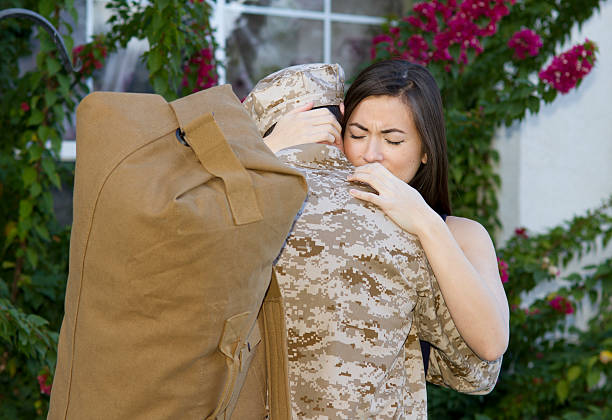 istock Military Man Deploys Wife Hugs Horizontal 484622979