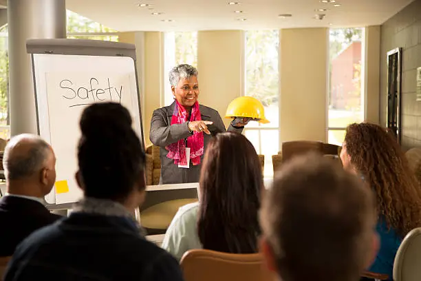 Photo of Safety in the workplace. Presentation with office workers.