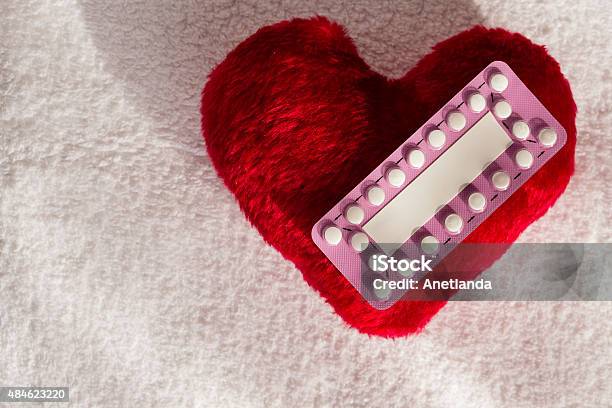 Oral Contraceptive Pills On Red Heart Stock Photo - Download Image Now - 2015, Activity, Birth Control Pill