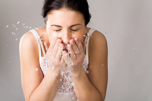 Image of pretty woman washing her face with pure water   Note to inspector: the image is pre-Sept 1 2009