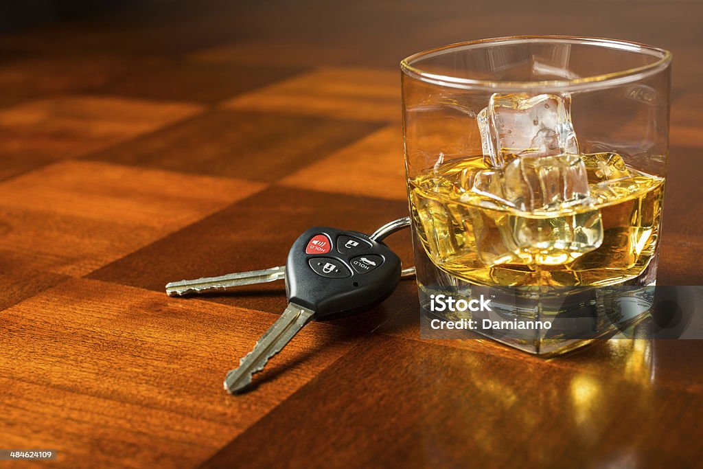 Drinking and Driving Car keys with glass of whiskey on table, drinking and driving concept Drunk Driving Stock Photo