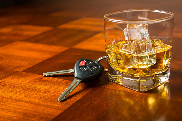 Drinking and Driving Car keys with glass of whiskey on table, drinking and driving concept driving under the influence stock pictures, royalty-free photos & images