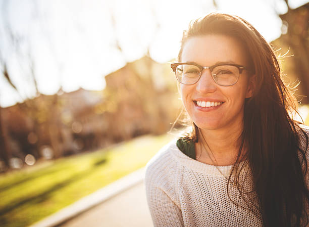 istock brunette smiling woman at sunset 484624767