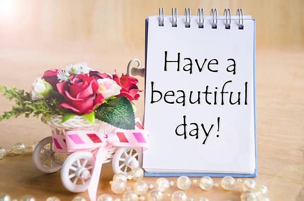 istock Have a nice day on open diary and and red rose. 484625968