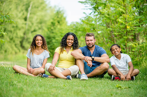 istock Family Sitting Together in the Grass 484626068