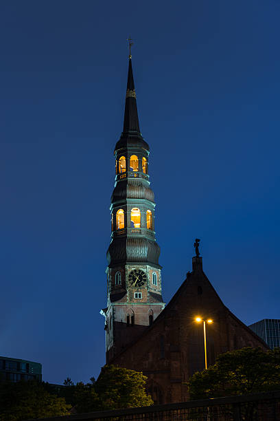 Tower with clock from famous Michel (St. Michaelis) Church in Hamburg, Germany at night