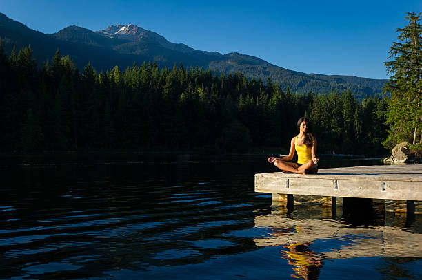 istock Easy Pose Tranquil Lakeside meditation at sunrise 484628666