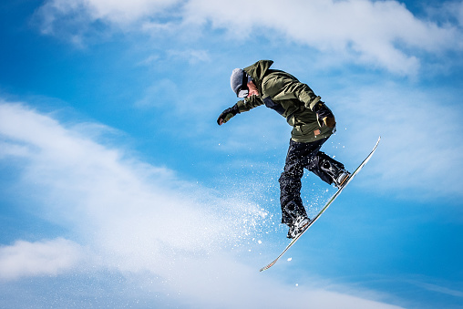 Snowboarder in a mid-air jump.