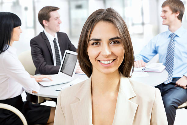 istock Happy business woman with colleagues 484631190