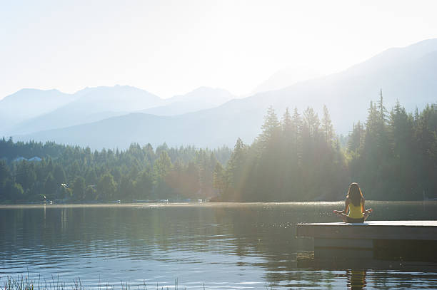 istock Easy Pose Tranquil Lakeside meditation at sunrise 484631324