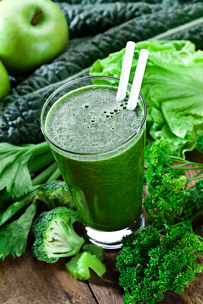 istock Green vegetable juice on rustic wood table 484632526