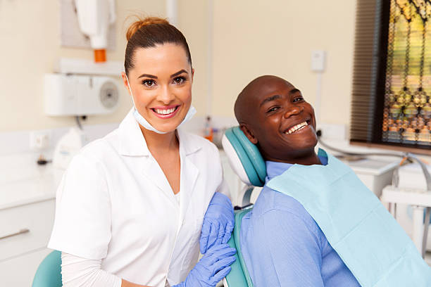 istock young female dentist and african patient 484637828