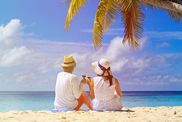 istock loving couple drinking wine at tropical beach 484638406